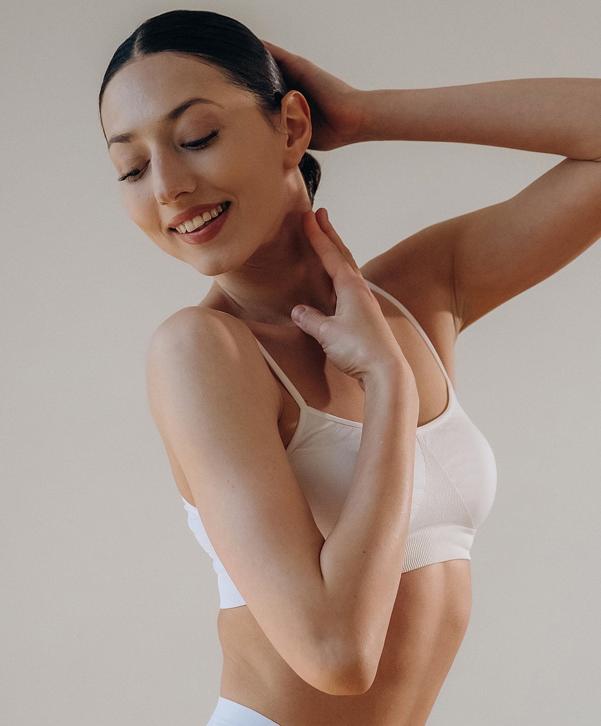 Woman gracefully posing in minimal attire.