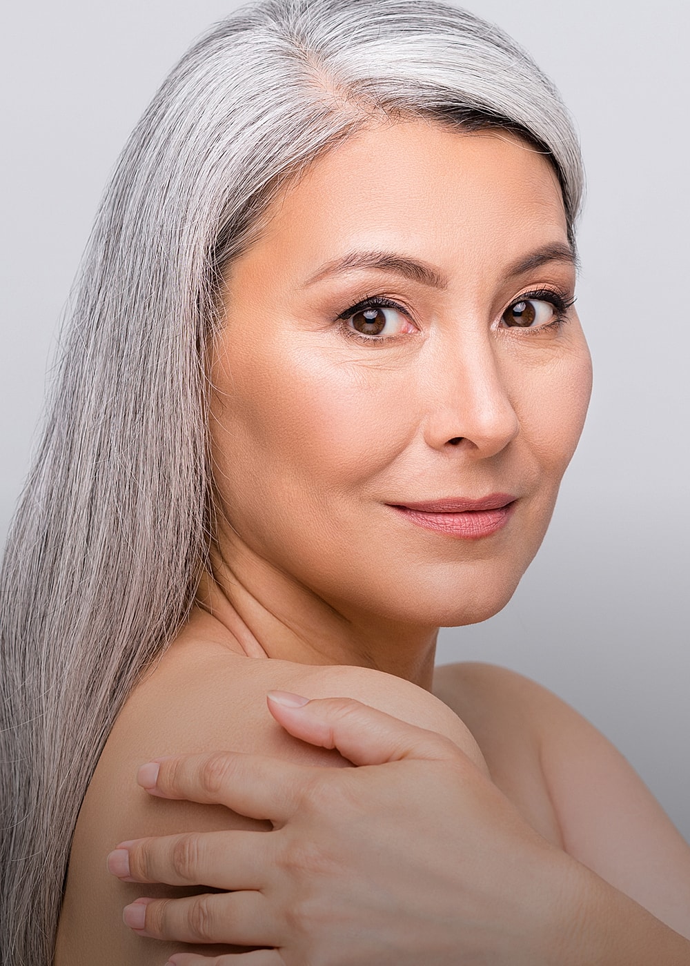 Portrait of a mature woman with silver hair.