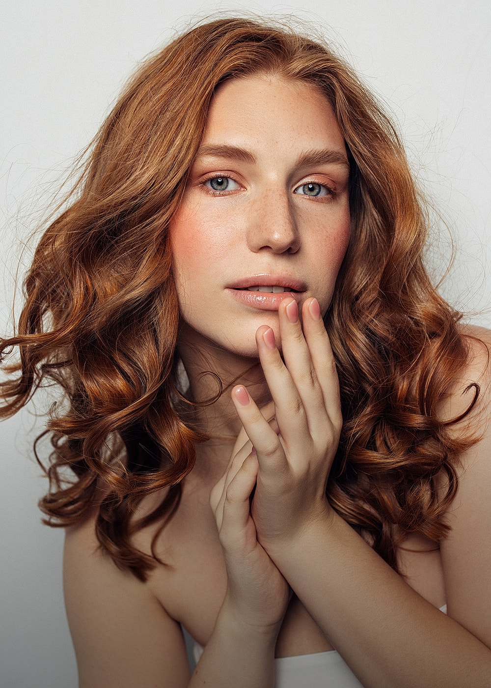 Portrait of a woman with curly red hair.