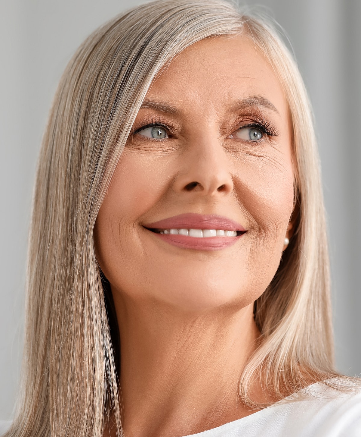 Charlotte, NC facelift model with long gray hair.