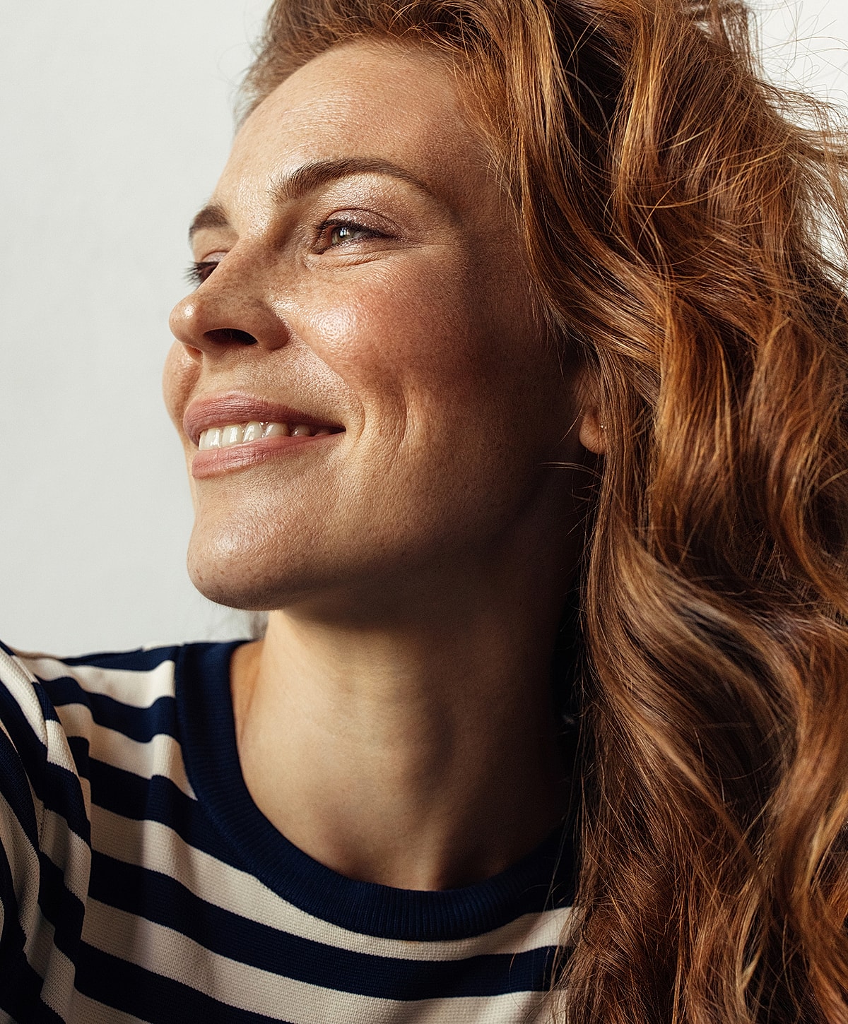 Charlotte, NC IPL Laser model with wavy red hair.
