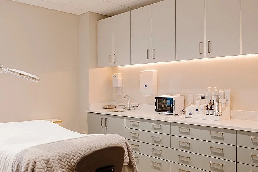 Modern skincare treatment room with organized supplies.