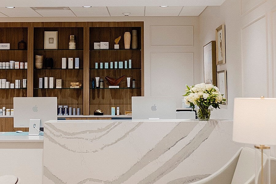 Modern beauty clinic reception with skincare products.