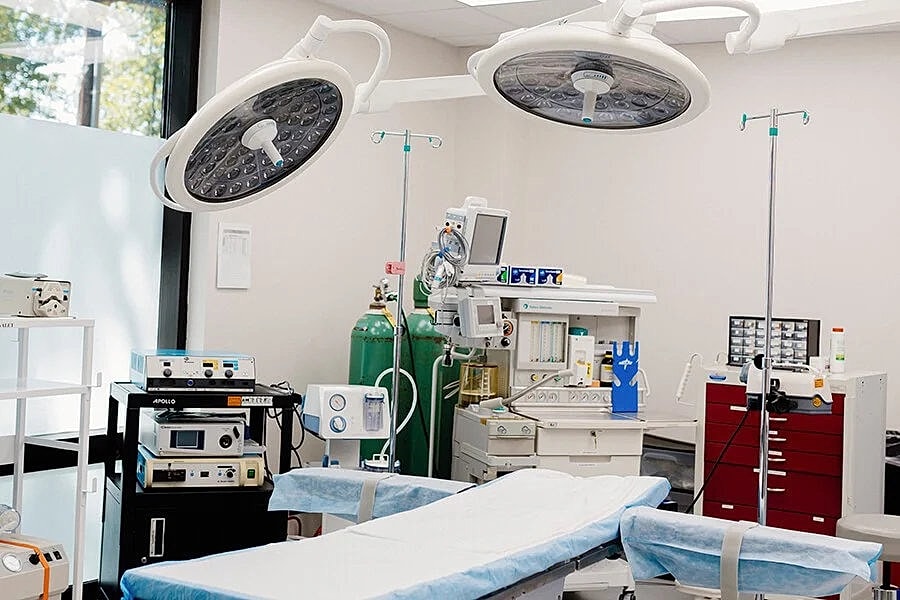 Surgery room equipped with medical instruments and lights.