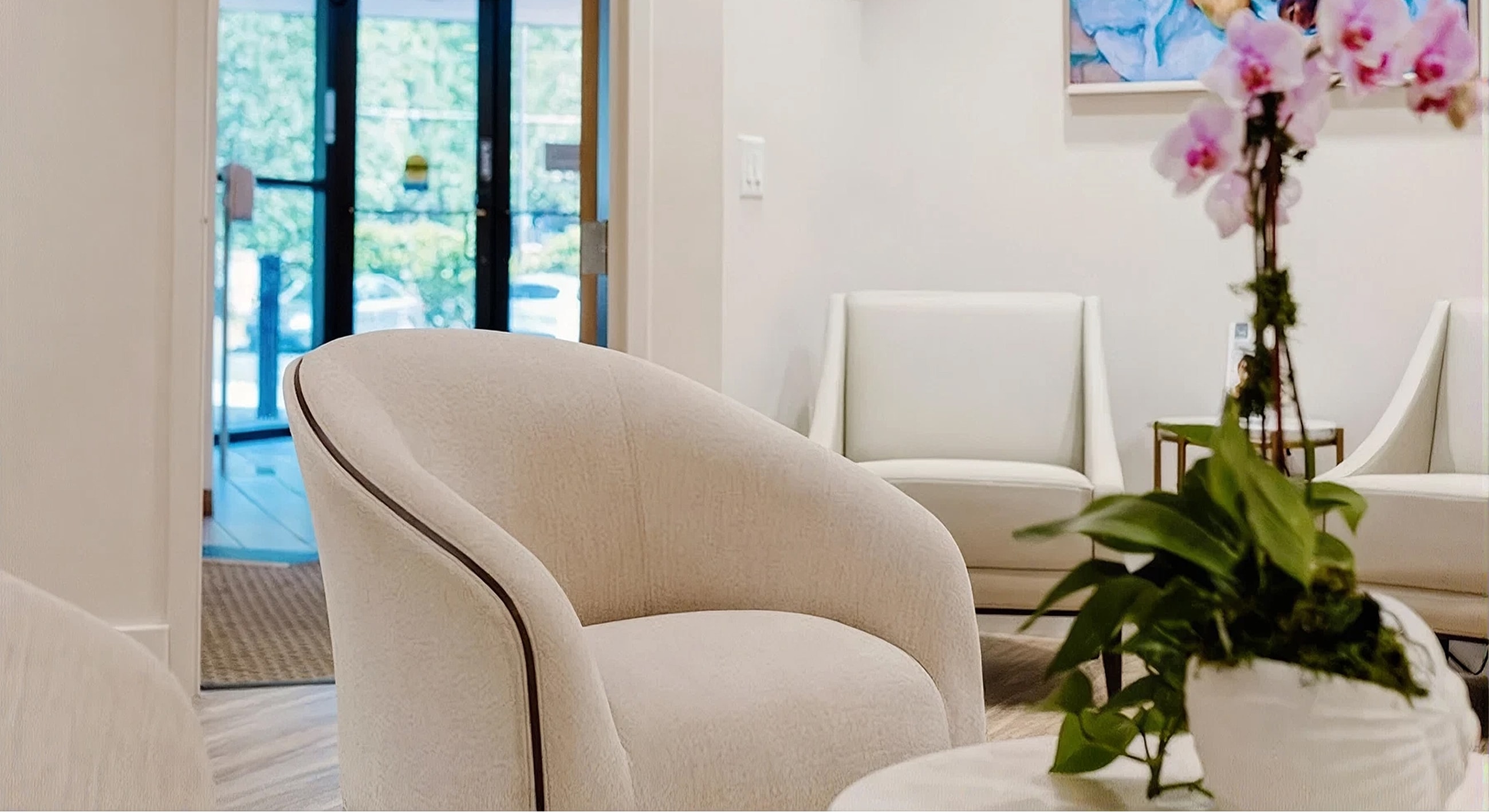 Modern waiting room with soft seating and plants