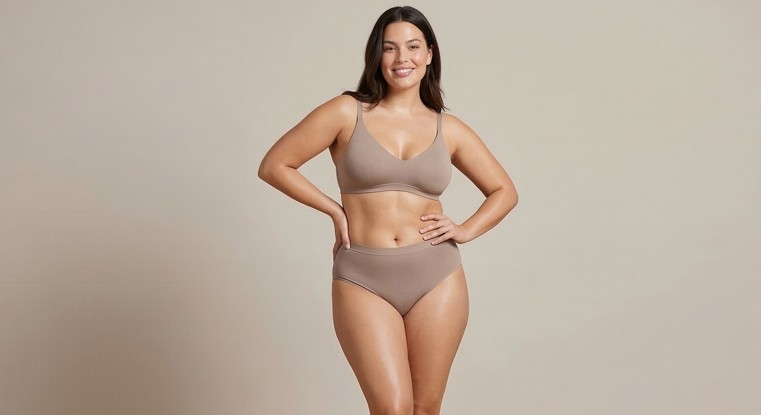 Model wearing brown lingerie, smiling confidently.