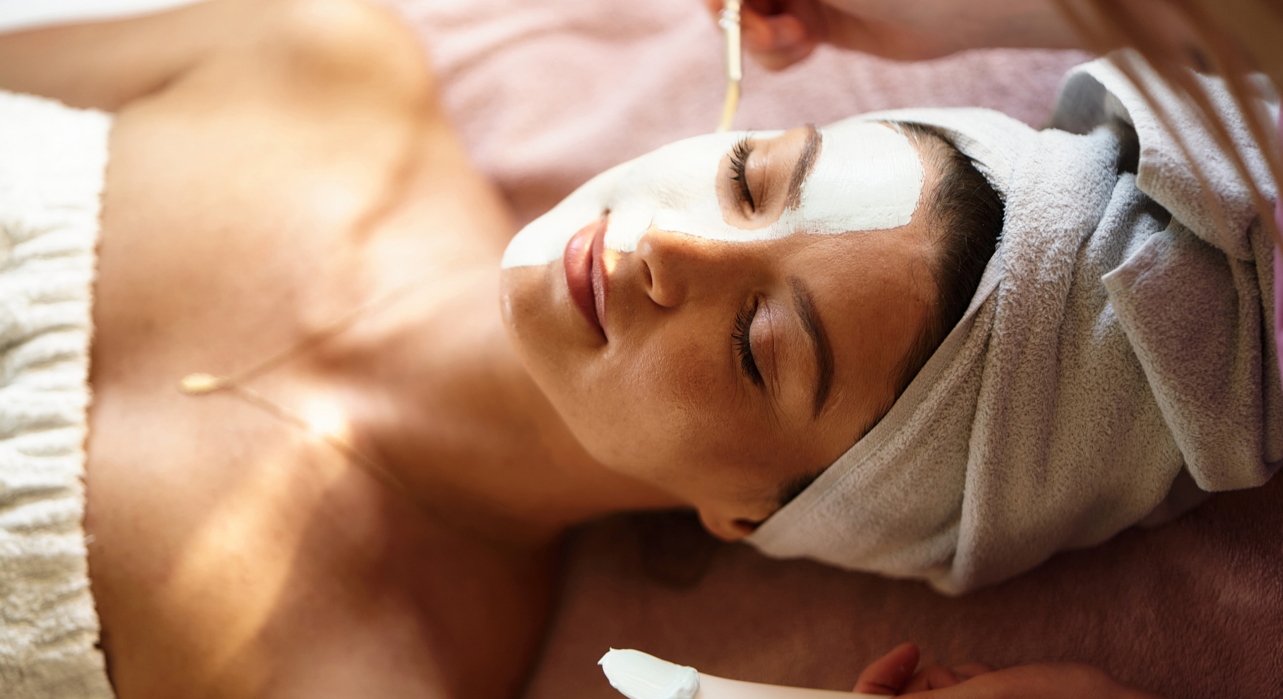 Woman receiving facial treatment in a spa.