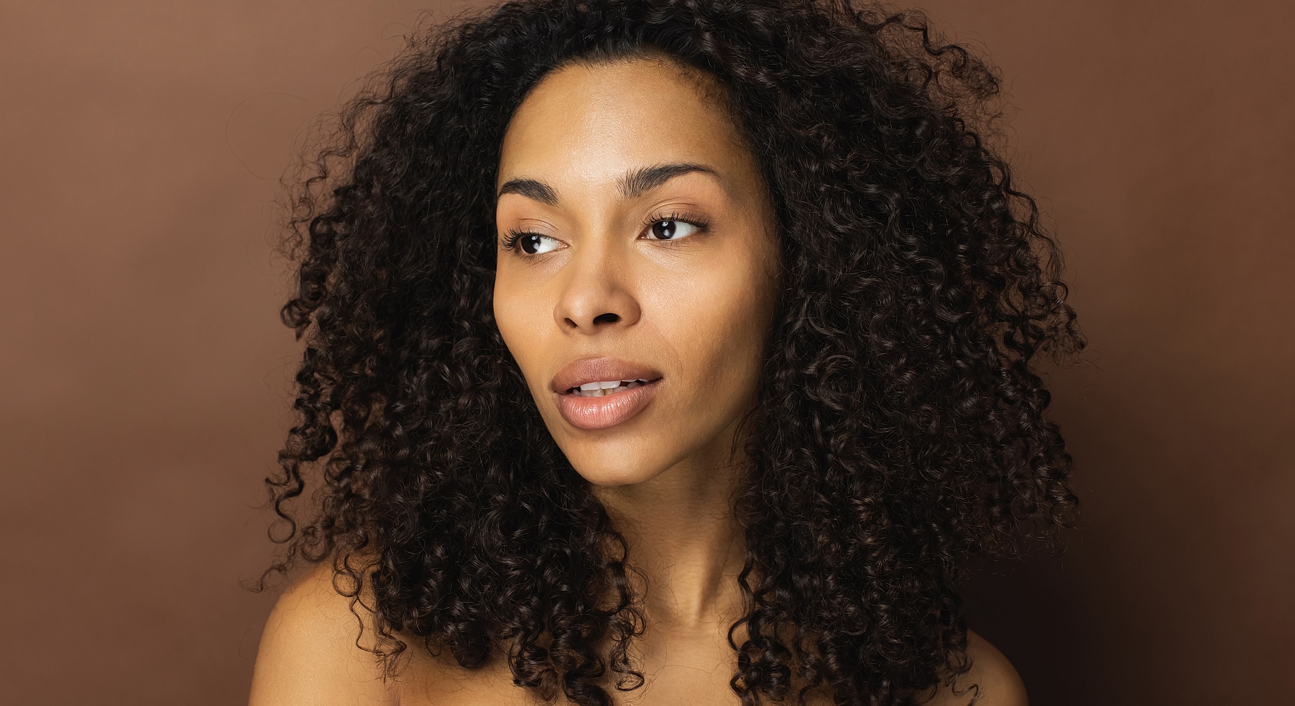 Portrait of a woman with curly hair.